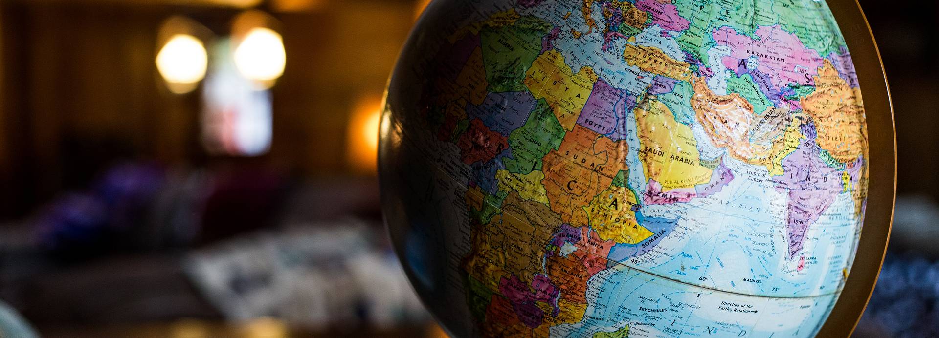A globe of the Earth stands on a table at the front of a room.