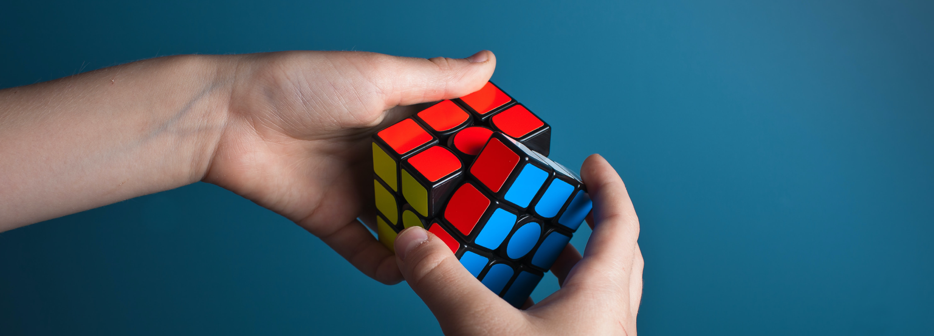A Rubik's cube about to be solved, with the red, blue and yellow faces in view.