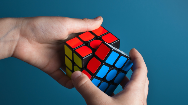 A Rubik's cube about to be solved, with the red, blue and yellow faces in view.
