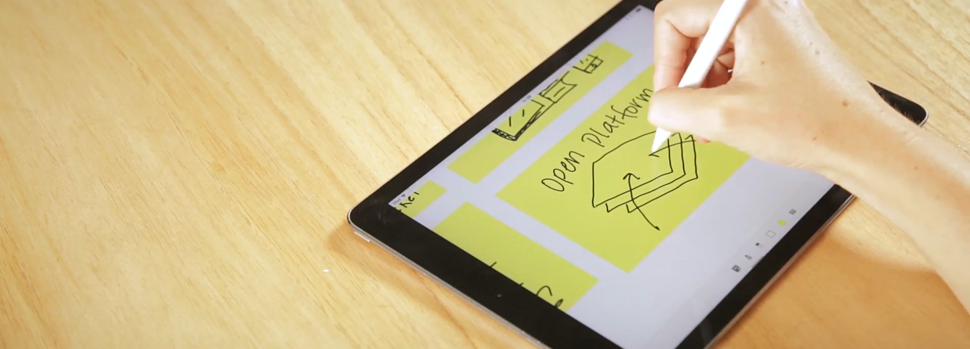 An Apple Pencil is used on an iPad Pro to draw notes onto a post-it in Mural.